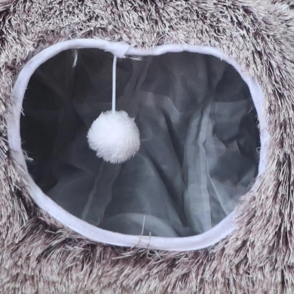Close-up of a textured surface with a white pom-pom hanging inside a circular opening.