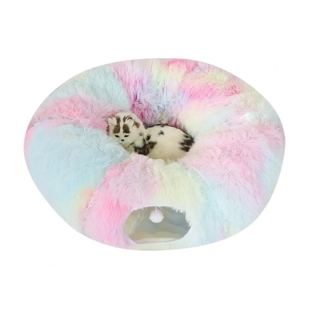 Pastel-colored donut pet bed with a small animal peeking out on a white background